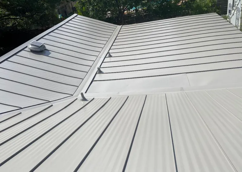 Solar attic fan installed on a metal roof for Roof Ventilation in Farmers Branch